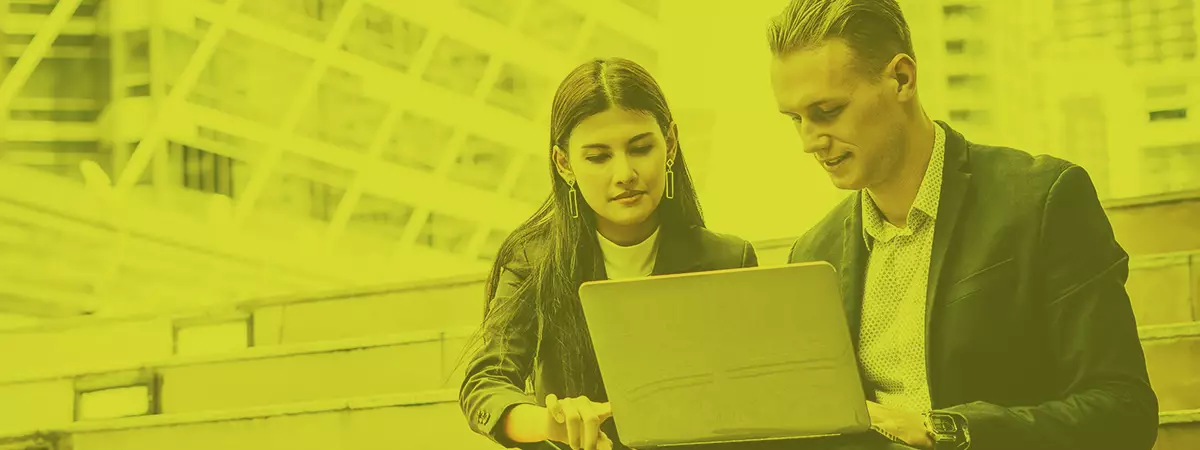 Business coworkers discussing new ideas and brainstorming on laptop sitting on staircase office